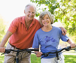 Photo of a man and woman on bicycles. 